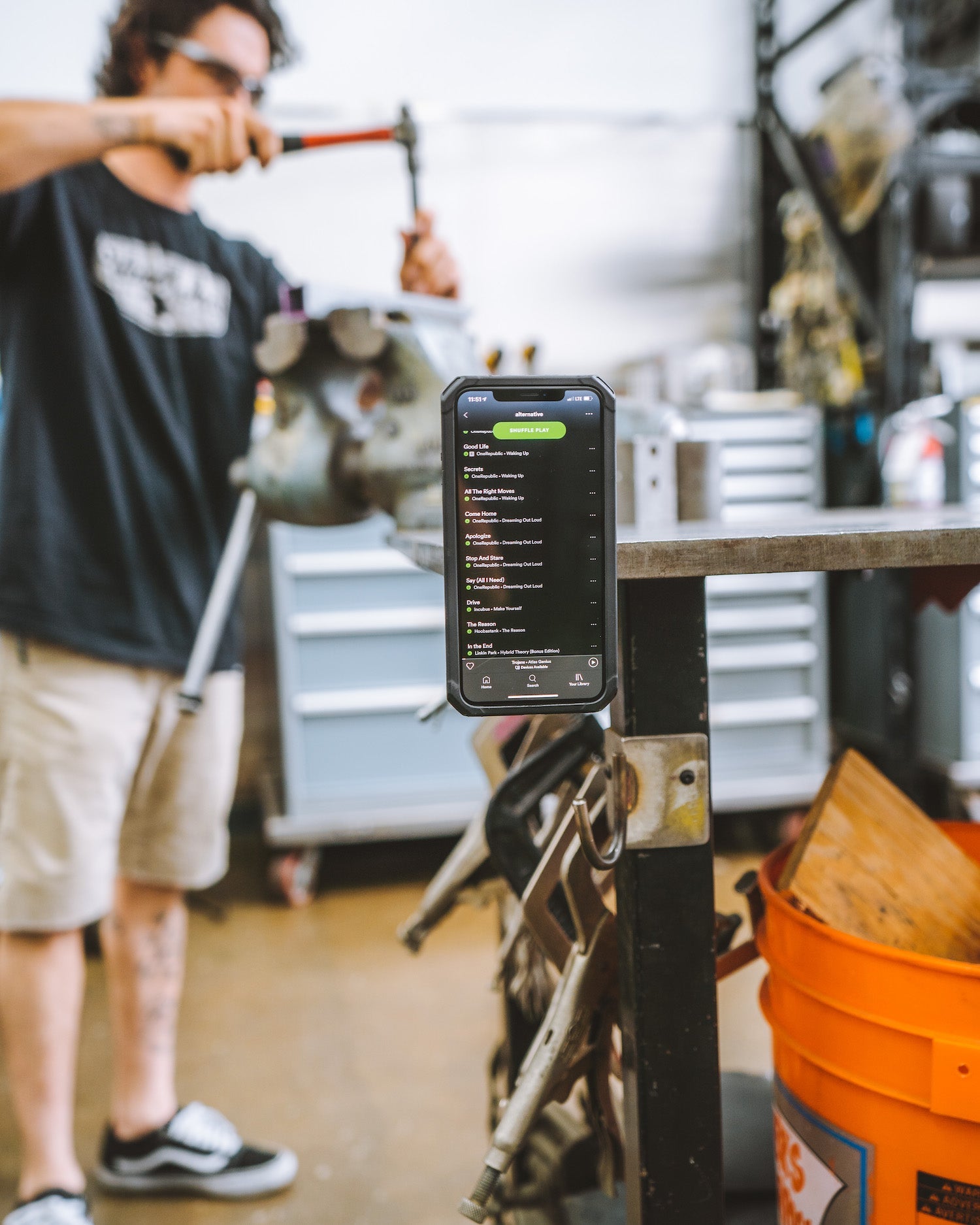 Man using magnetic phone case in garage