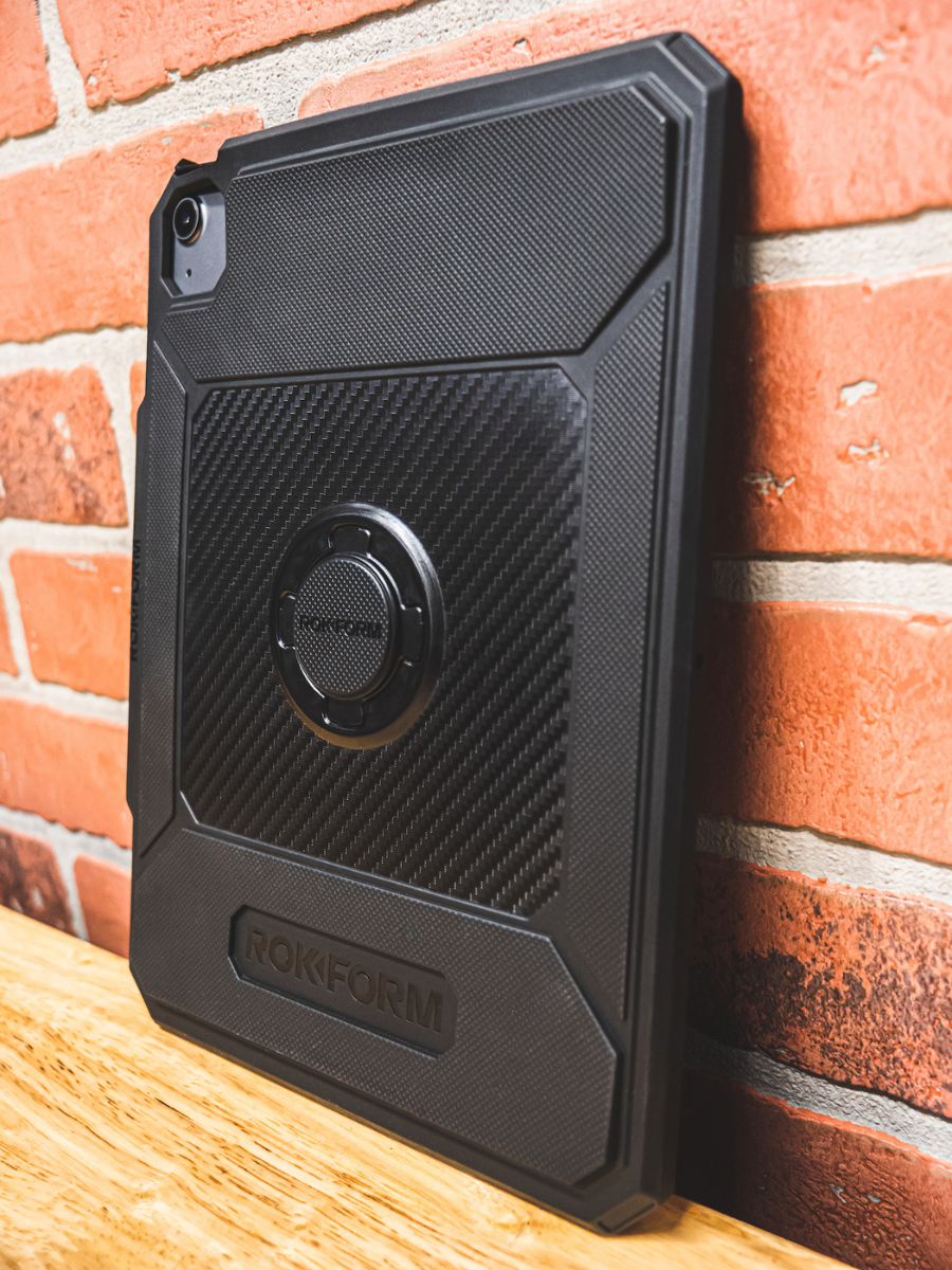  Close-up photo of man holding iPad with ROKFORM Rugged iPad Case